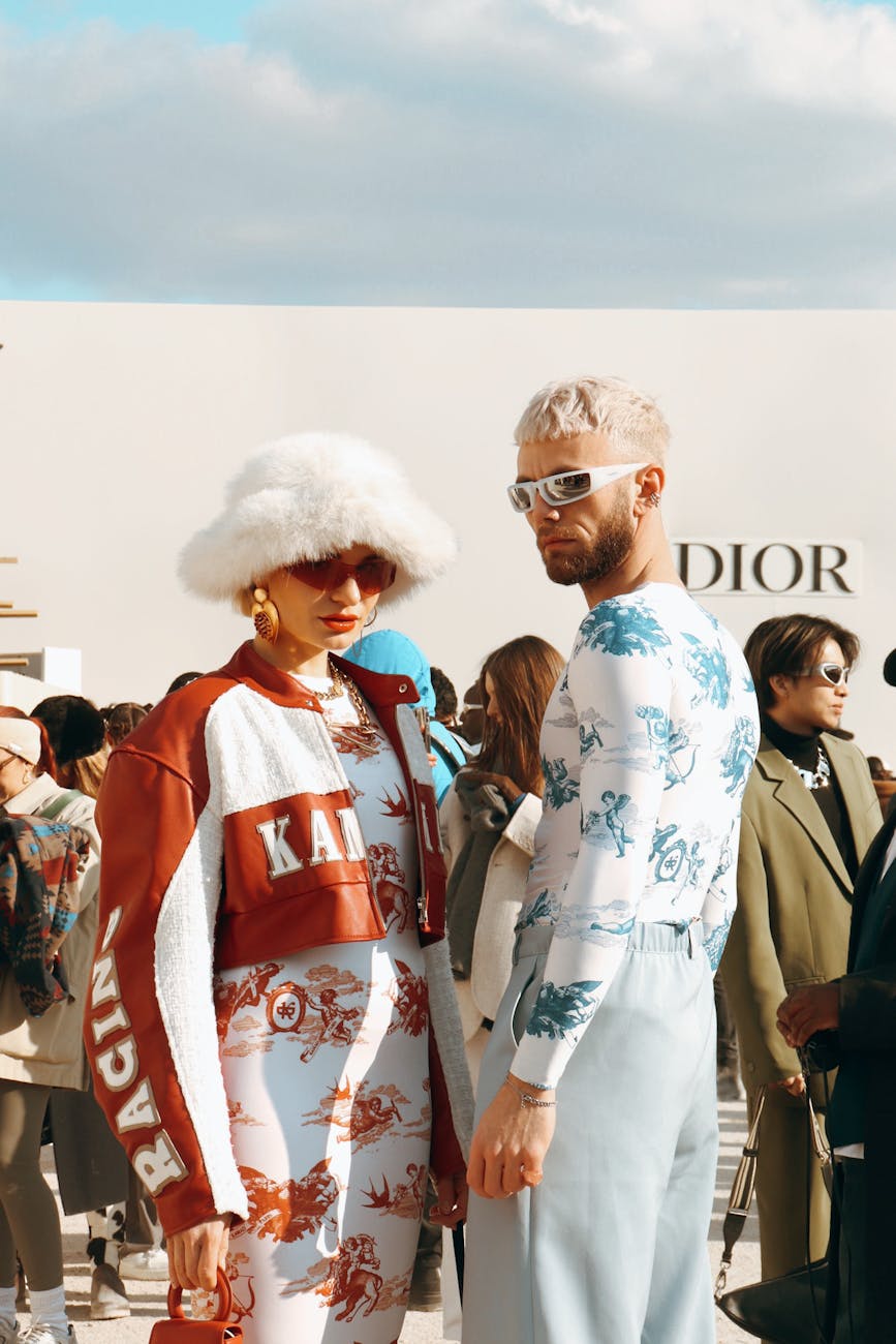 two people standing next to each other at a fashion show