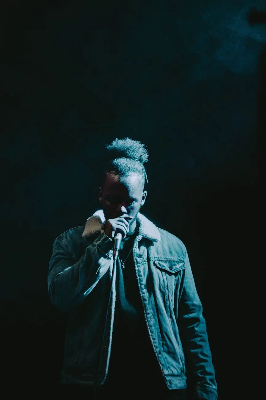 man wearing denim jacket singing on stage