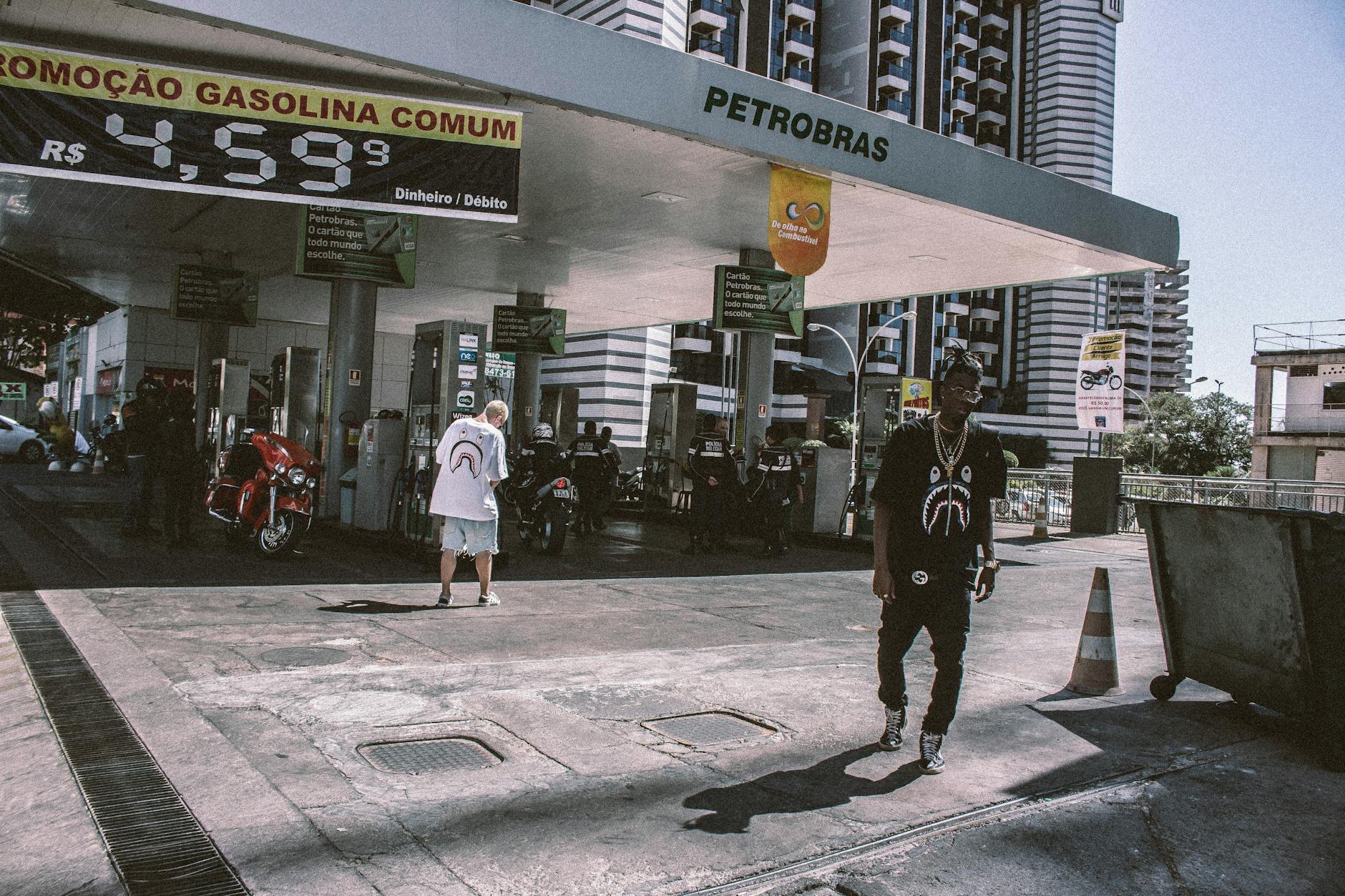 man walking behind petrobras gasoline station
